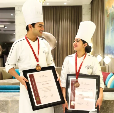 Two Eggfree baking chefs showing certificates